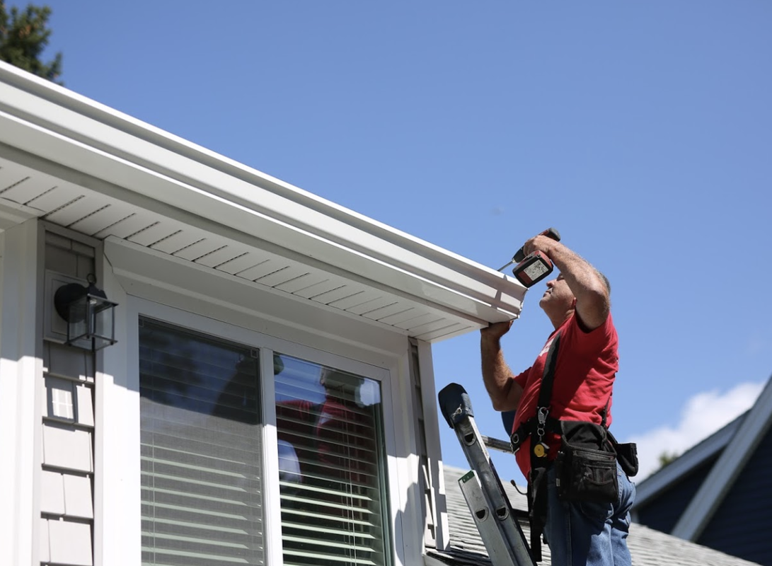 Picture of Doyle installing gutter on a home in Yulee, FL
