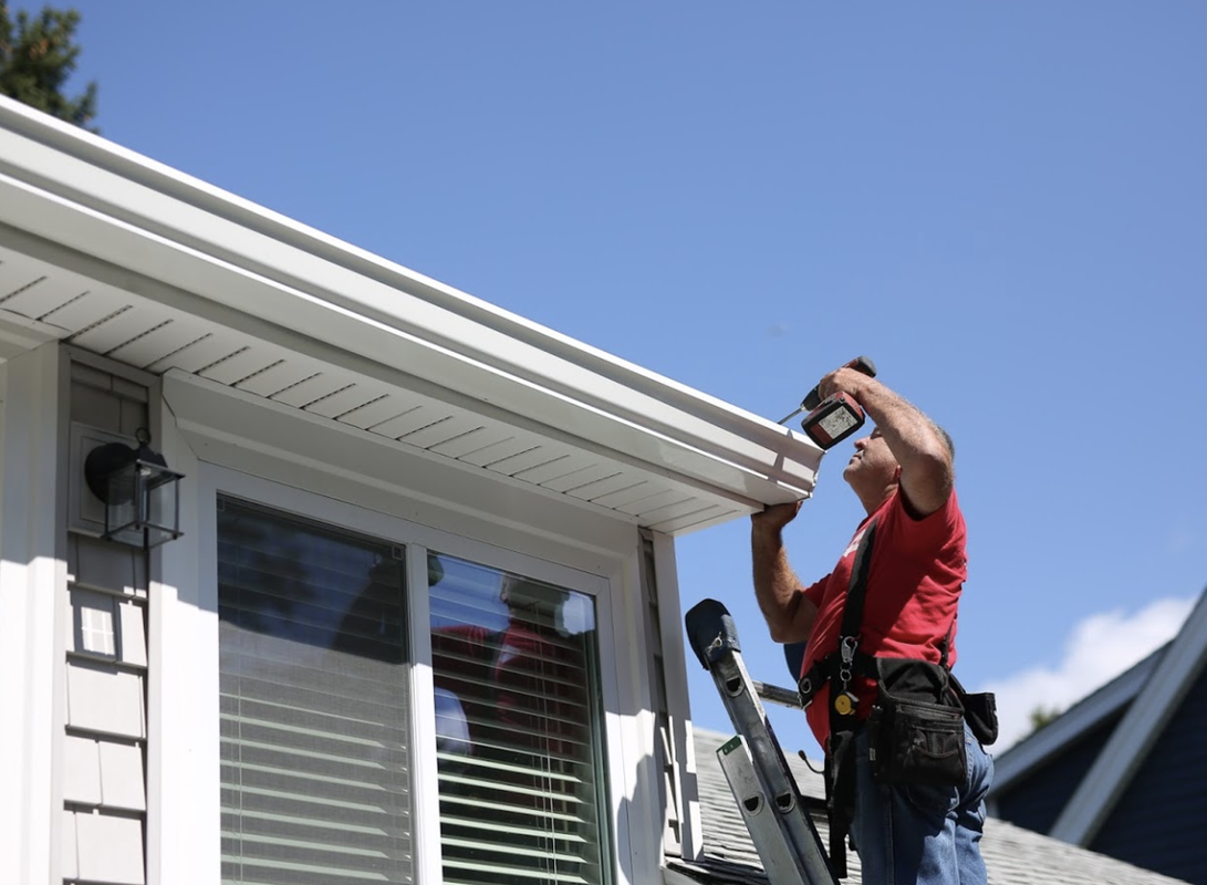 Gutter Installer instilling gutters