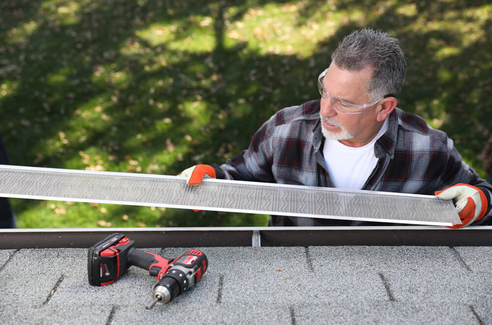 Gutter Guard Installer installing gutter guards